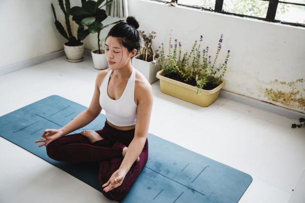 asian woman meditating in a yoga studio