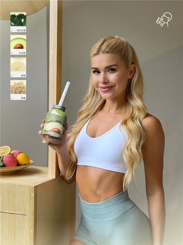 a person holding a layered dessert in a jar surrounded by fresh fruits