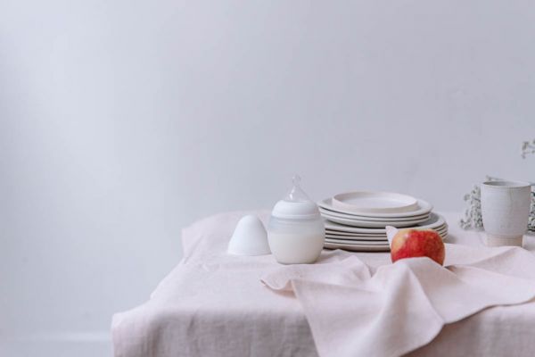 eating well while breastfeeding, a set table and a bottle elhee
