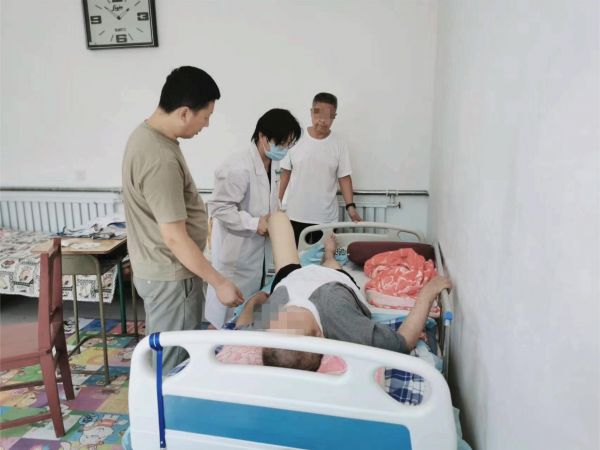 圖1：中心康復(fù)治療師劉江為家屬進(jìn)行指導(dǎo)_副本.jpg