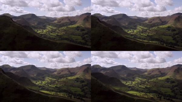 英格兰湖区的航拍镜头，展示了人们徒步旅行的壮丽景色。