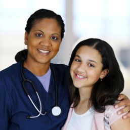 nurse and little girl smiling