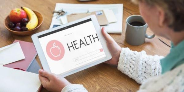 Woman looking at the digital signage that promotes health and wellness.