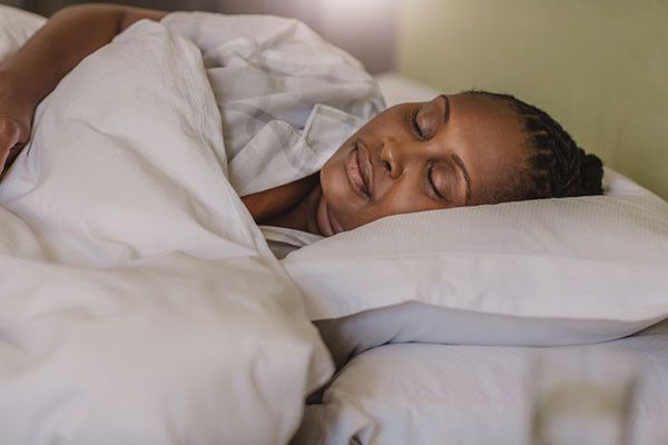 photo of a mature woman sleeping soundly on her side