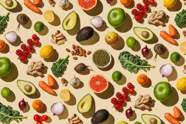 pattern of variety fresh of organic fruits and vegetables and healthy vegan meal ingredients on beige background healthy food, clean eating, diet and detox, eco friendly, no plastic concept flat lay, top view