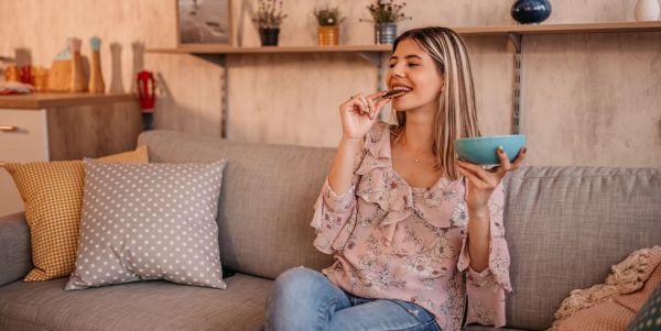 beautiful woman eating cookies at home