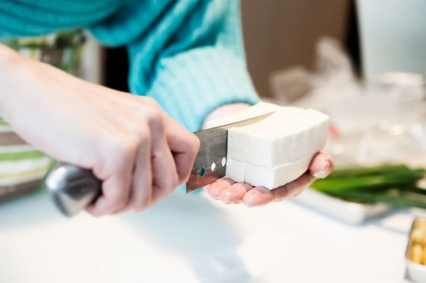cut tofu on hands