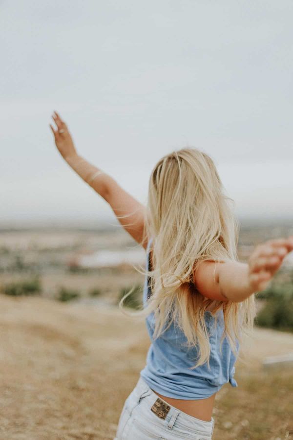 A happy, healthy woman as an example of holistic wellness.