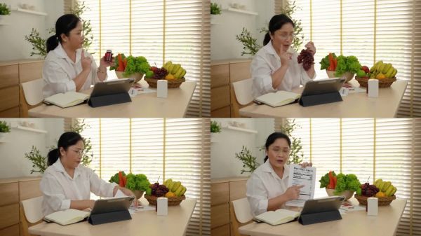 专业营养师亚洲中年妇女介绍水果和蔬菜的饮食替代品和水果和蔬菜提取物的营养饮食，是有益健康的患者在线，