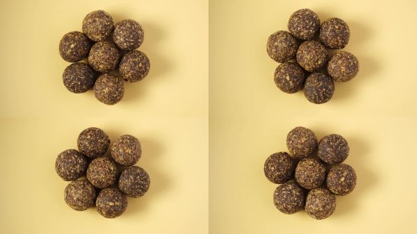 含有干枣、角豆、蜂蜜和不同坚果的能量球。健康的自制糖果。素食圆形糖果，俯视图。视频中,旋转