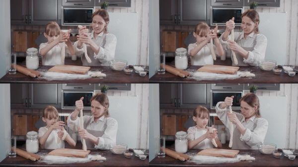 媽媽和女兒拉伸面包面團