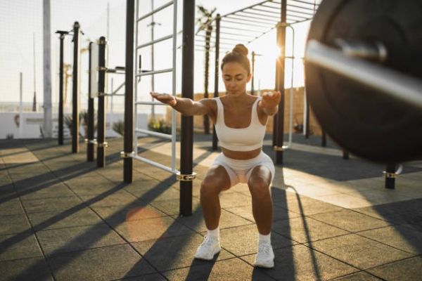 young woman with strong athletic body training on sports venue endurance street workout persistence and effort, goal achievement in sports physical activity and healthy lifestyle