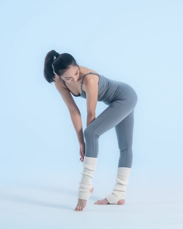 individual performing a stretch in athletic wear