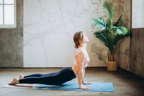 Woman stretching on yoga mat for National Wellness Month activity