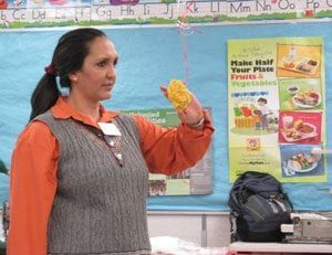 Teacher showing example about nutrition in classroom