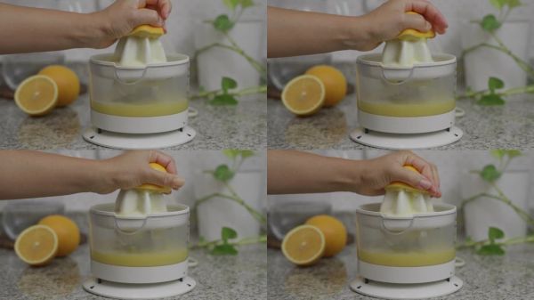 在柑橘榨汁機中擠壓橙子。