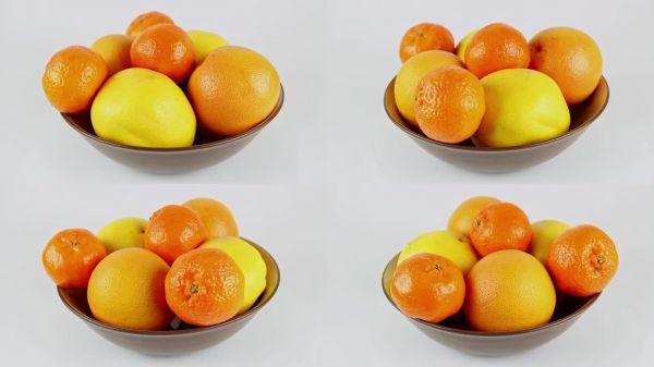 白色背景下的碗中盛放着柑橘类水果