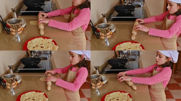 孩子在廚房用搟面杖和咖啡器具制作自制平面餅。