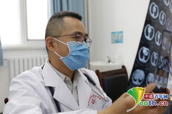 图为北京医院急诊内科主任医师陈燕启在看患者的CT影像。中国青年网记者 王龙龙 摄