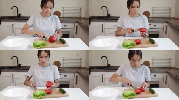 做沙拉，少女在廚房切番茄，年輕女性準(zhǔn)備健康晚餐食譜。