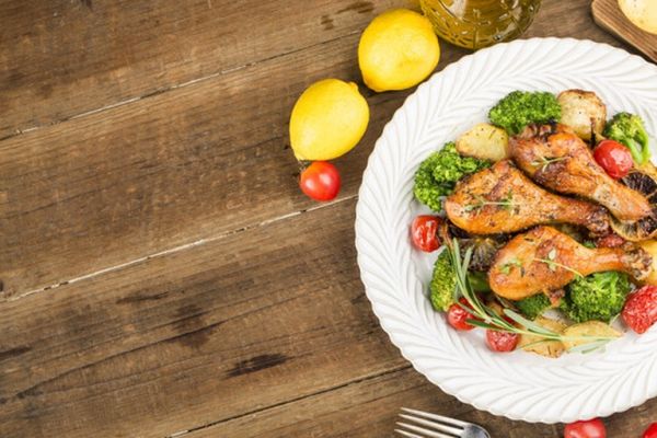 一份以鸡胸肉为主的减脂餐盘，配有西兰花、小番茄和柠檬片装饰