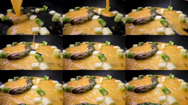 春季蔬菜煎蛋卷的制作，配以新鮮的蘆筍和蔥，在平底鍋中烹飪。